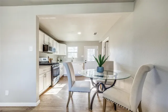 a view of a dining room with furniture and a potted plant