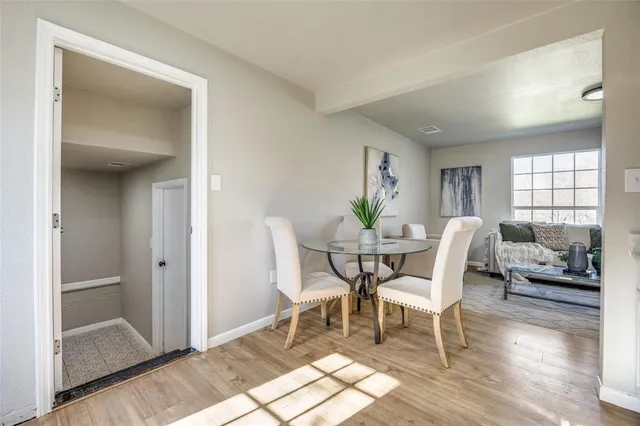 a dining room with furniture and wooden floor