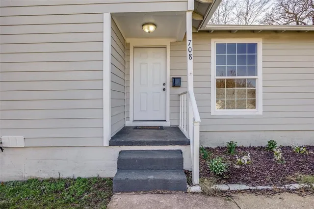 a front view of a house with plants
