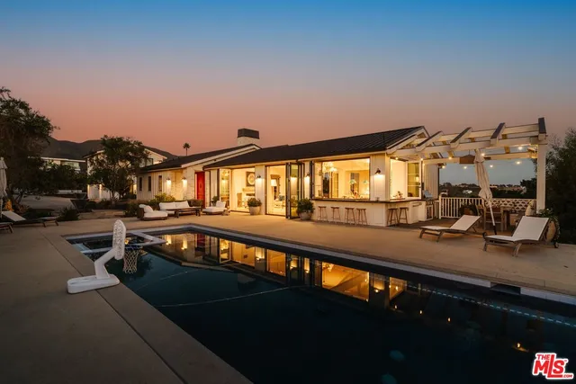 a view of a swimming pool with seating area