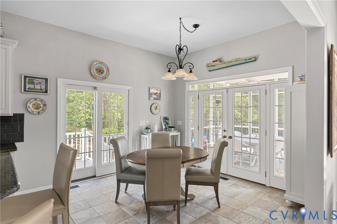 935 Ring Farm Road White Stone, VA 22578 - Photo 18 of 52 Dining area featuring french doors and a chandelie
