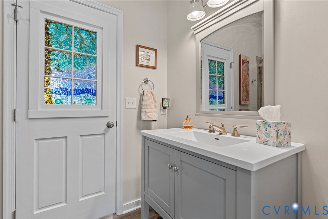 935 Ring Farm Road White Stone, VA 22578 - Photo 32 of 52 Bathroom featuring vanity and dark wood-style floo