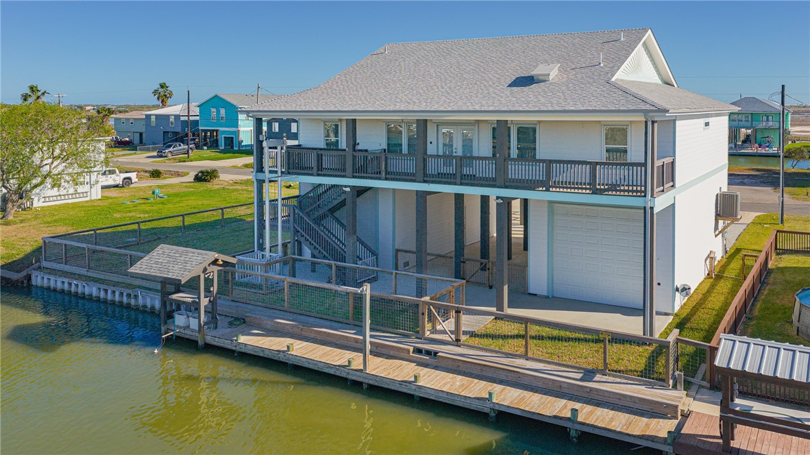 a view of a house with swimming pool and a chairs