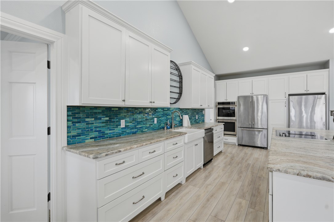 142-143 Channelview Road Rockport, TX 78382 - Photo 16 of 40 a kitchen with granite countertop white cabinets and stainless steel appliances