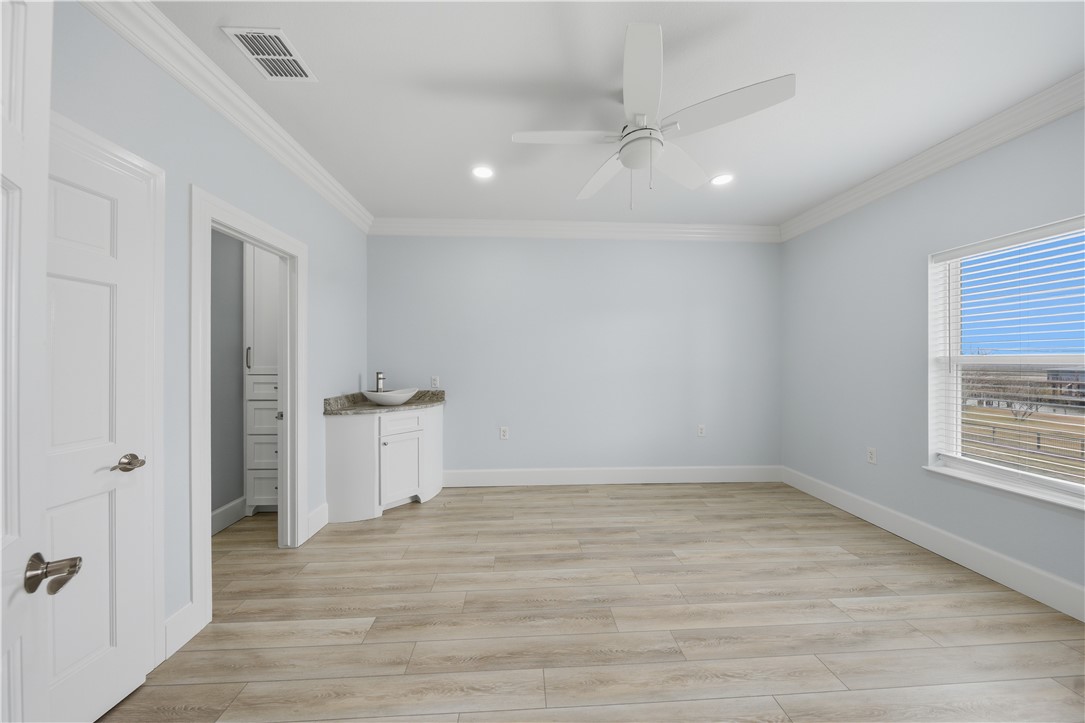 142-143 Channelview Road Rockport, TX 78382 - Photo 19 of 40 wooden floor in an empty room with a window