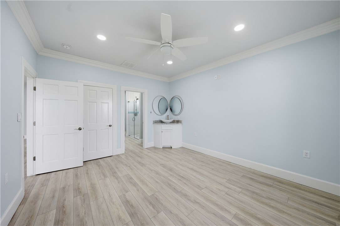 142-143 Channelview Road Rockport, TX 78382 - Photo 20 of 40 a room with wooden floor and white walls