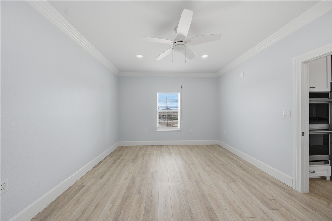 142-143 Channelview Road Rockport, TX 78382 - Photo 21 of 40 wooden floor in an empty room with a window