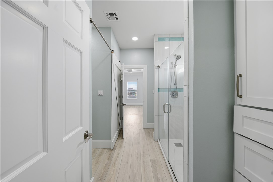 142-143 Channelview Road Rockport, TX 78382 - Photo 22 of 40 a view of a hallway with wooden floor and a bathroom