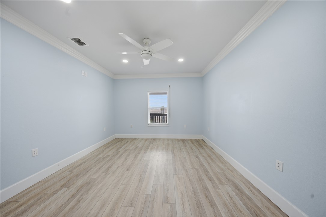 142-143 Channelview Road Rockport, TX 78382 - Photo 23 of 40 an empty room with wooden floor and windows