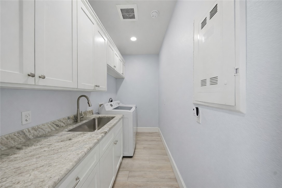 142-143 Channelview Road Rockport, TX 78382 - Photo 25 of 40 a kitchen with a sink and cabinets