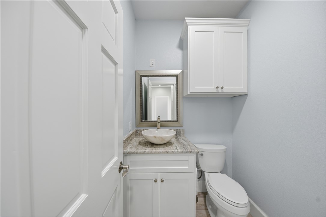 142-143 Channelview Road Rockport, TX 78382 - Photo 32 of 40 a bathroom with a granite countertop toilet and a sink