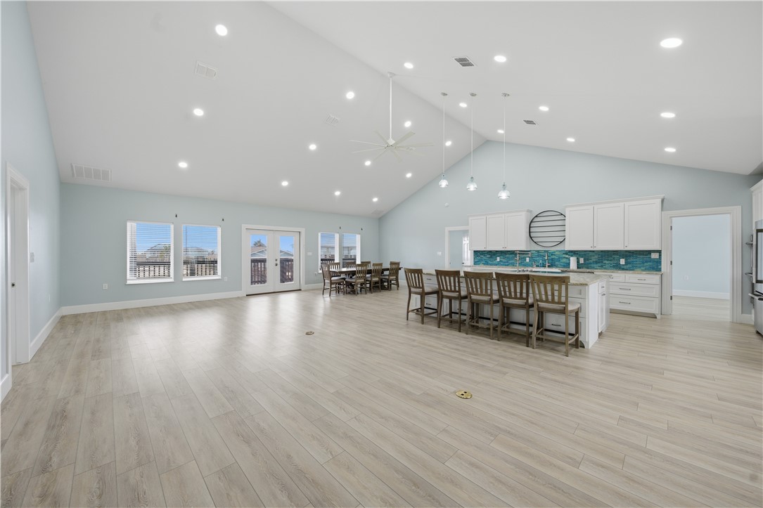 142-143 Channelview Road Rockport, TX 78382 - Photo 8 of 40 a room with stainless steel appliances wooden floor and large windows