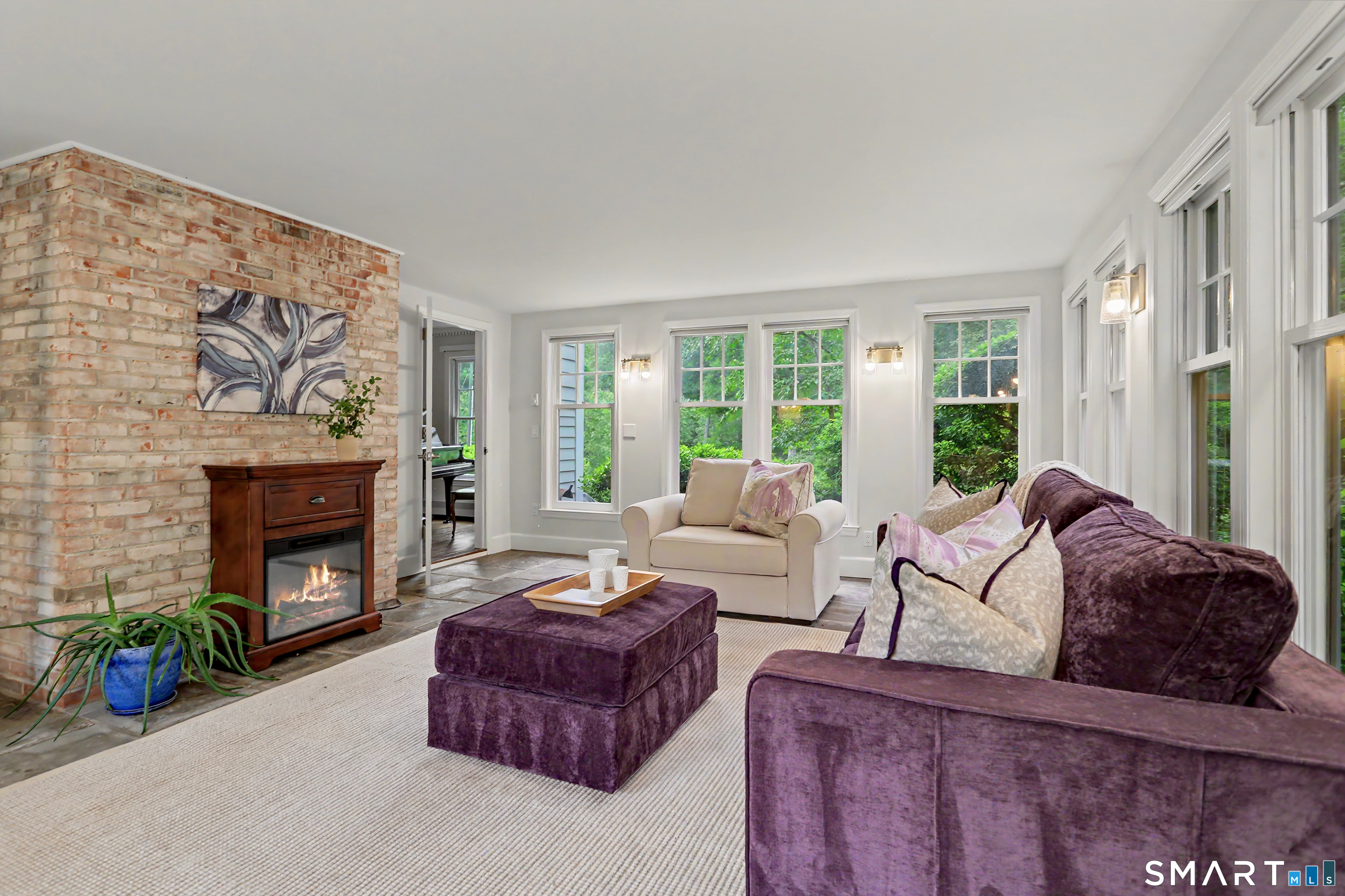 108 Logan Road New Canaan, CT 06840 - Photo 17 of 40 a living room with furniture and a fireplace