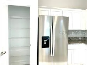 a bathroom with a glass door shower and a sink