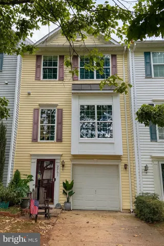 a view of a house with a tree and front view of a house