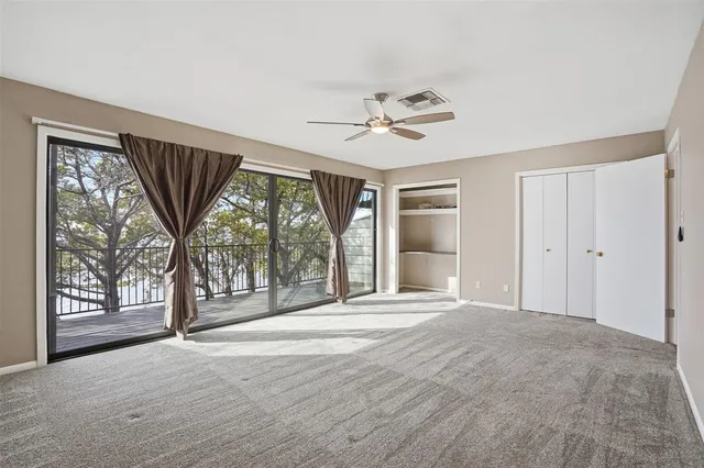 a view of an empty room with a fireplace and a large window