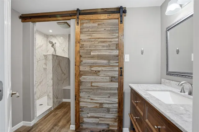 a bathroom with a shower and a sink