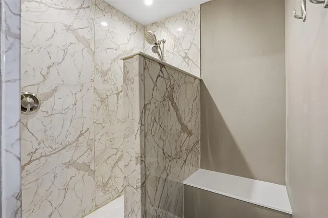 a bathroom with a shower and a mirror