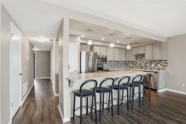 a large kitchen with a table and chairs