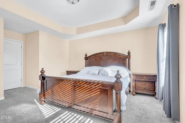 a bedroom with a bed and cabinets