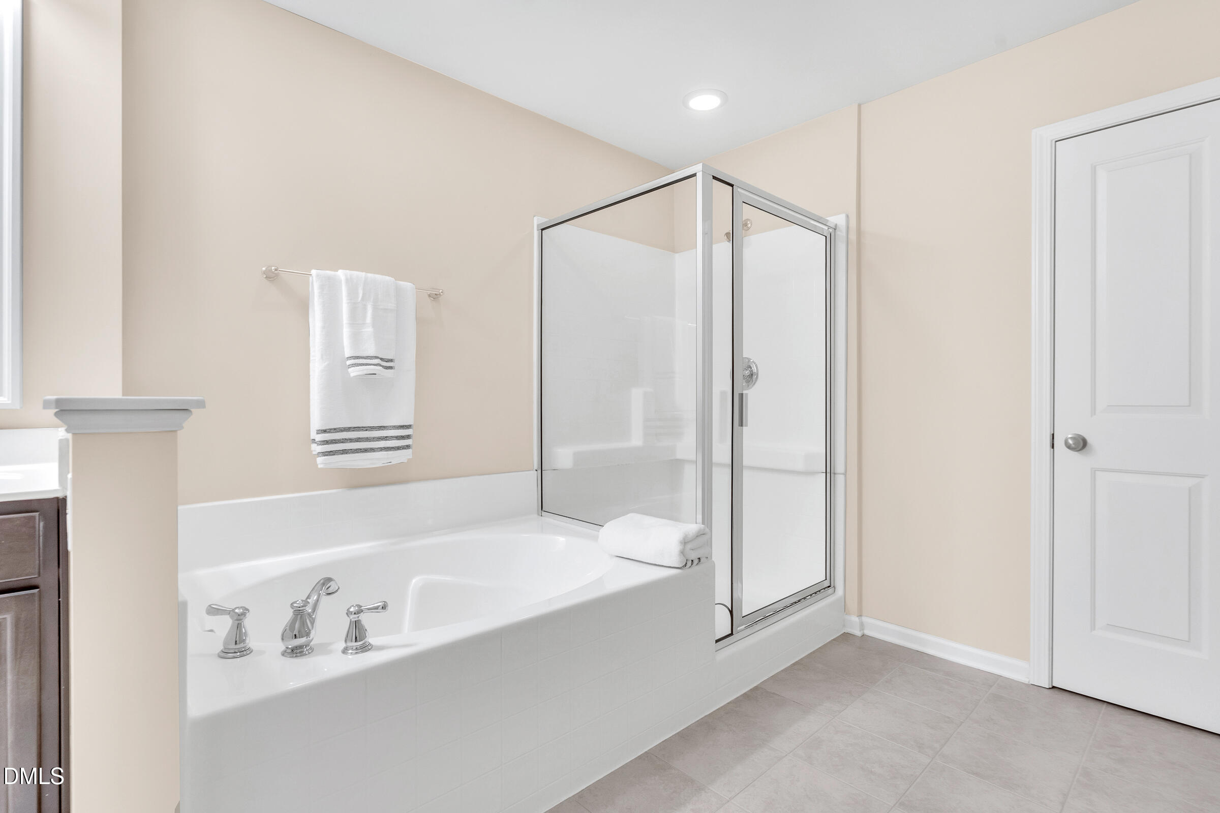 1304 Regulator Street Raleigh, NC 27603 - Photo 15 of 35 a bathroom with a bathtub and a shower