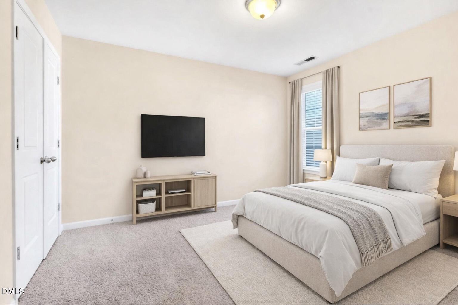 1304 Regulator Street Raleigh, NC 27603 - Photo 21 of 35 a bedroom with a bed and a flat screen tv