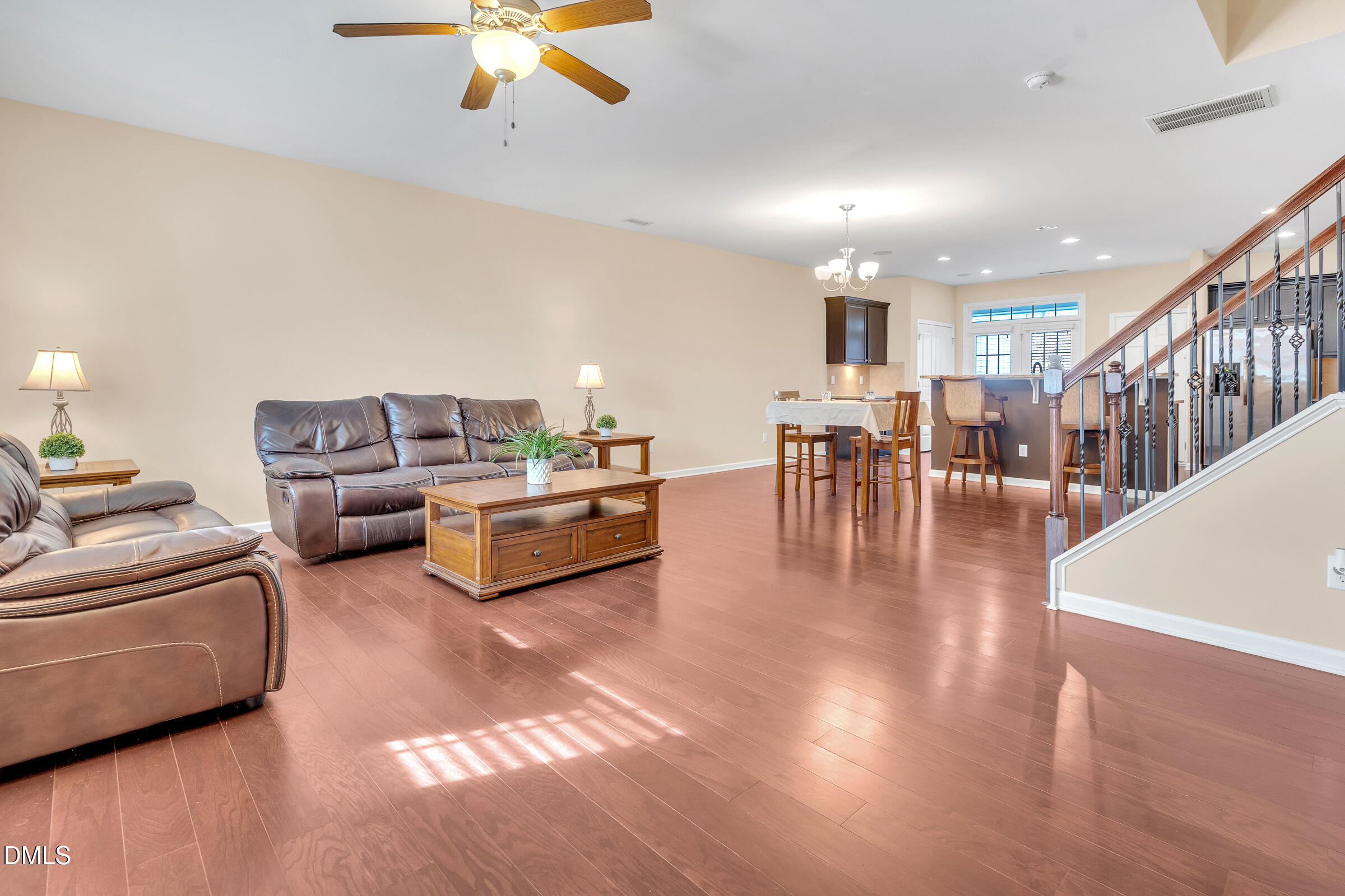 1304 Regulator Street Raleigh, NC 27603 - Photo 5 of 35 a living room with furniture and a dining table with wooden floor