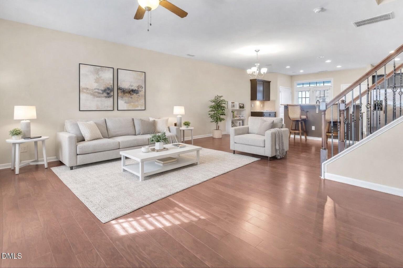 1304 Regulator Street Raleigh, NC 27603 - Photo 6 of 35 a living room with furniture and a chandelier
