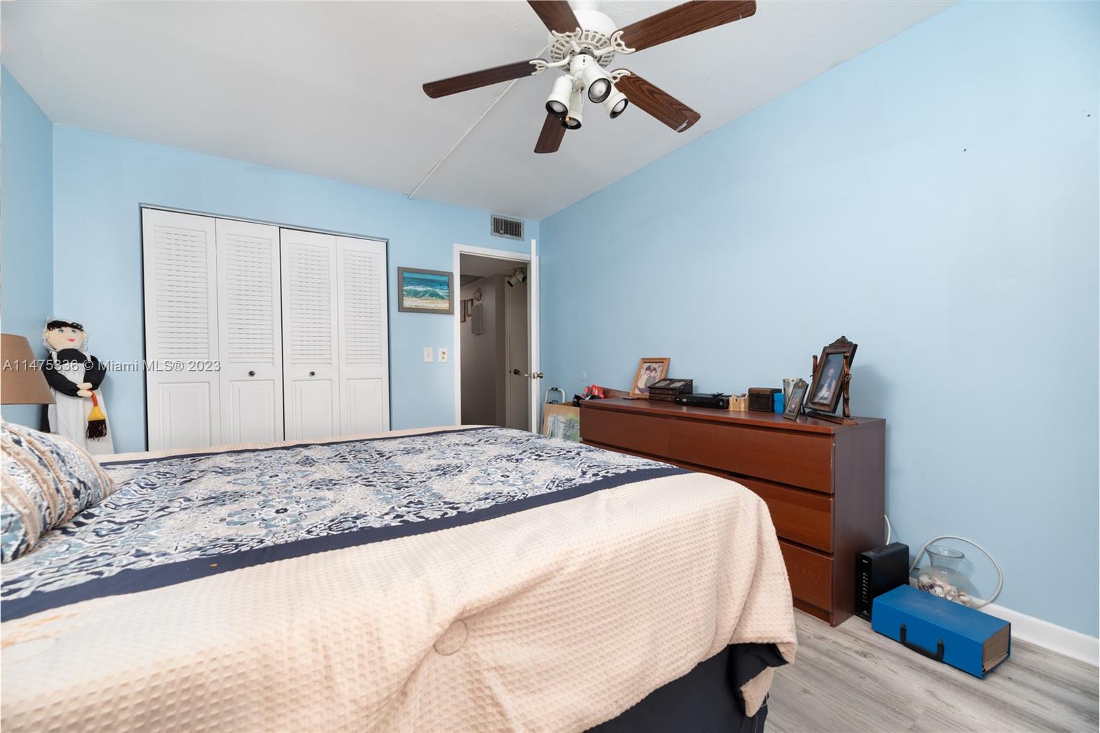 2085 Exeter, Unit 2085 Boca Raton, FL 33434 - Photo 12 of 20 a bedroom with a bed and a chandelier
