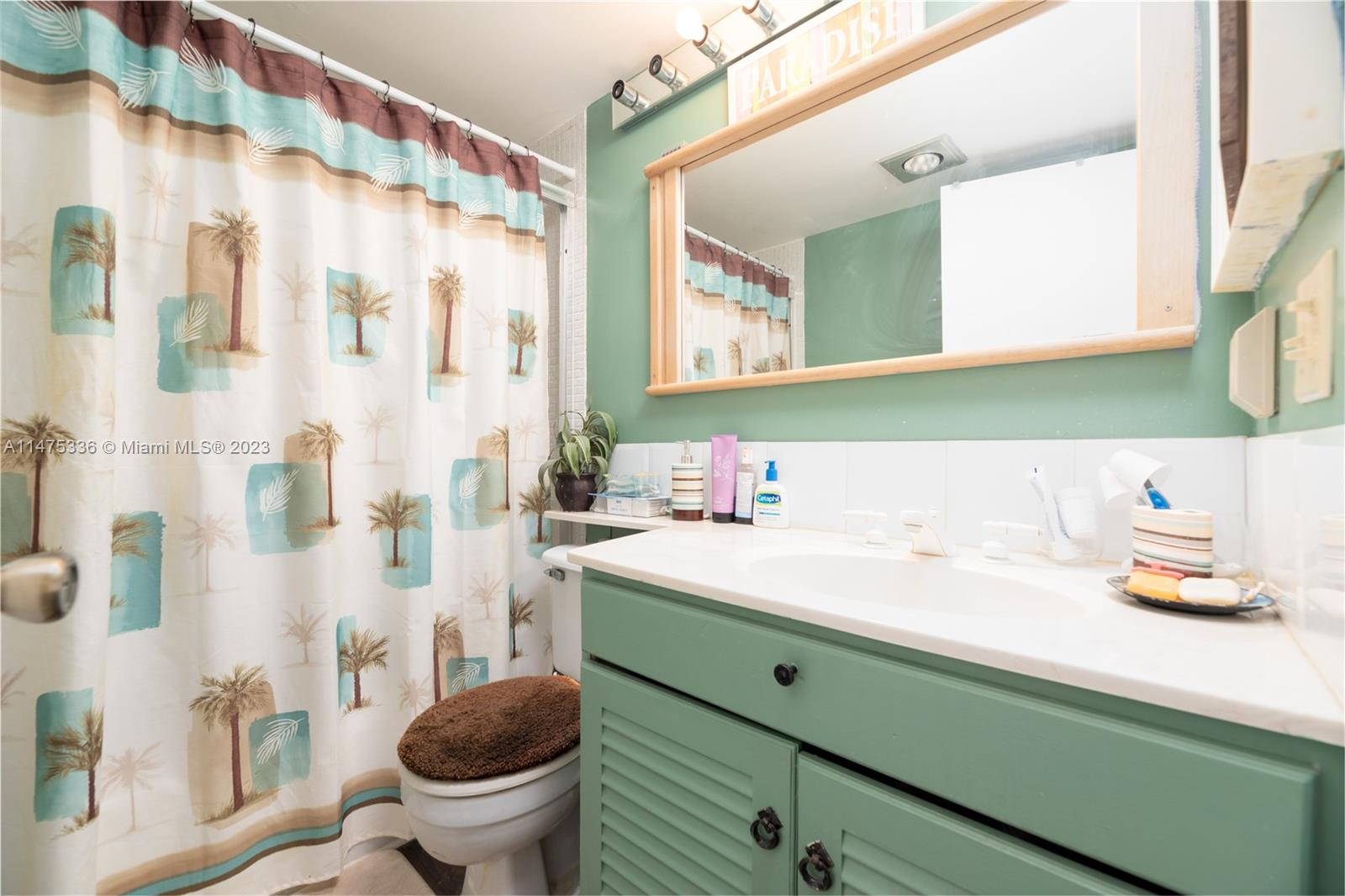 2085 Exeter, Unit 2085 Boca Raton, FL 33434 - Photo 13 of 20 a bathroom with a sink a toilet and a mirror