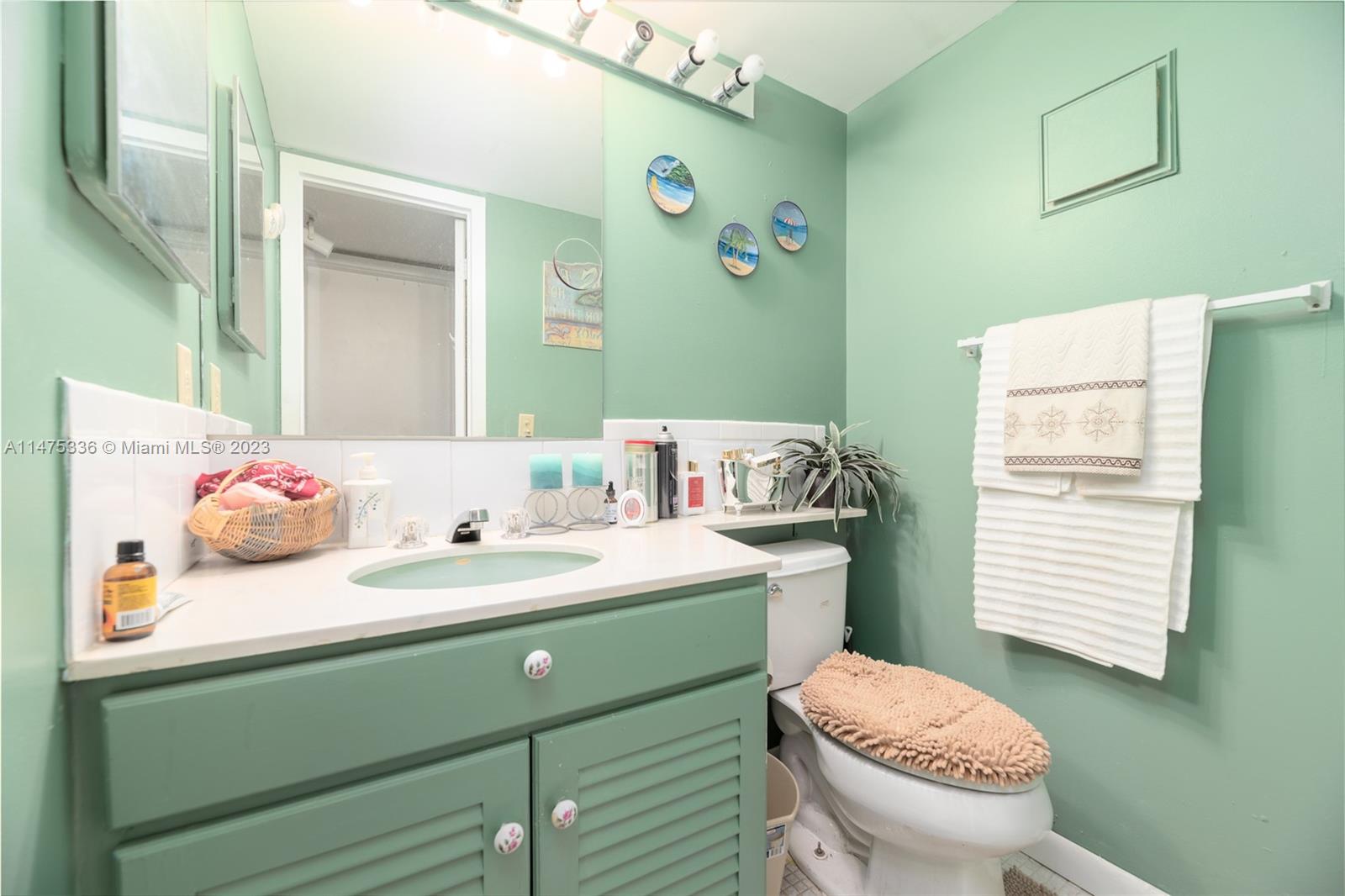 2085 Exeter, Unit 2085 Boca Raton, FL 33434 - Photo 14 of 20 a bathroom with a sink toilet and mirror