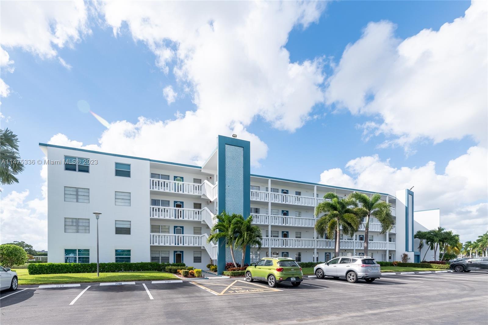 2085 Exeter, Unit 2085 Boca Raton, FL 33434 - Photo 20 of 20 a city street lined with buildings and cars