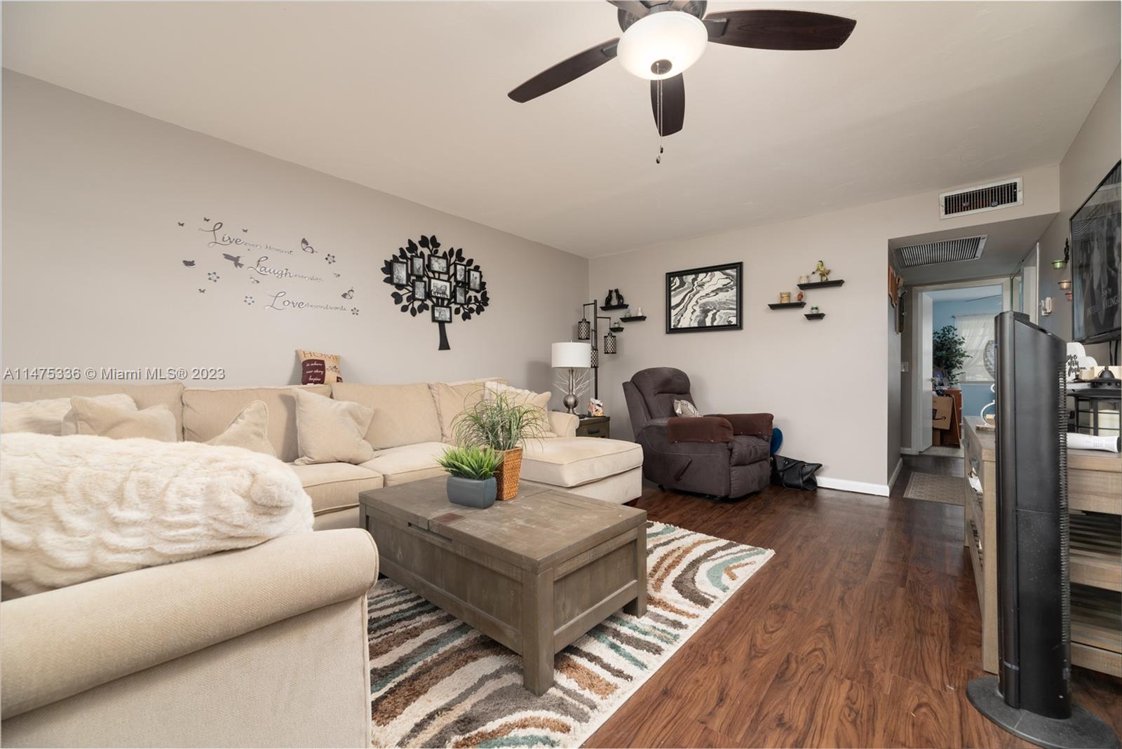 2085 Exeter, Unit 2085 Boca Raton, FL 33434 - Photo 2 of 20 a living room with furniture and a wooden floor