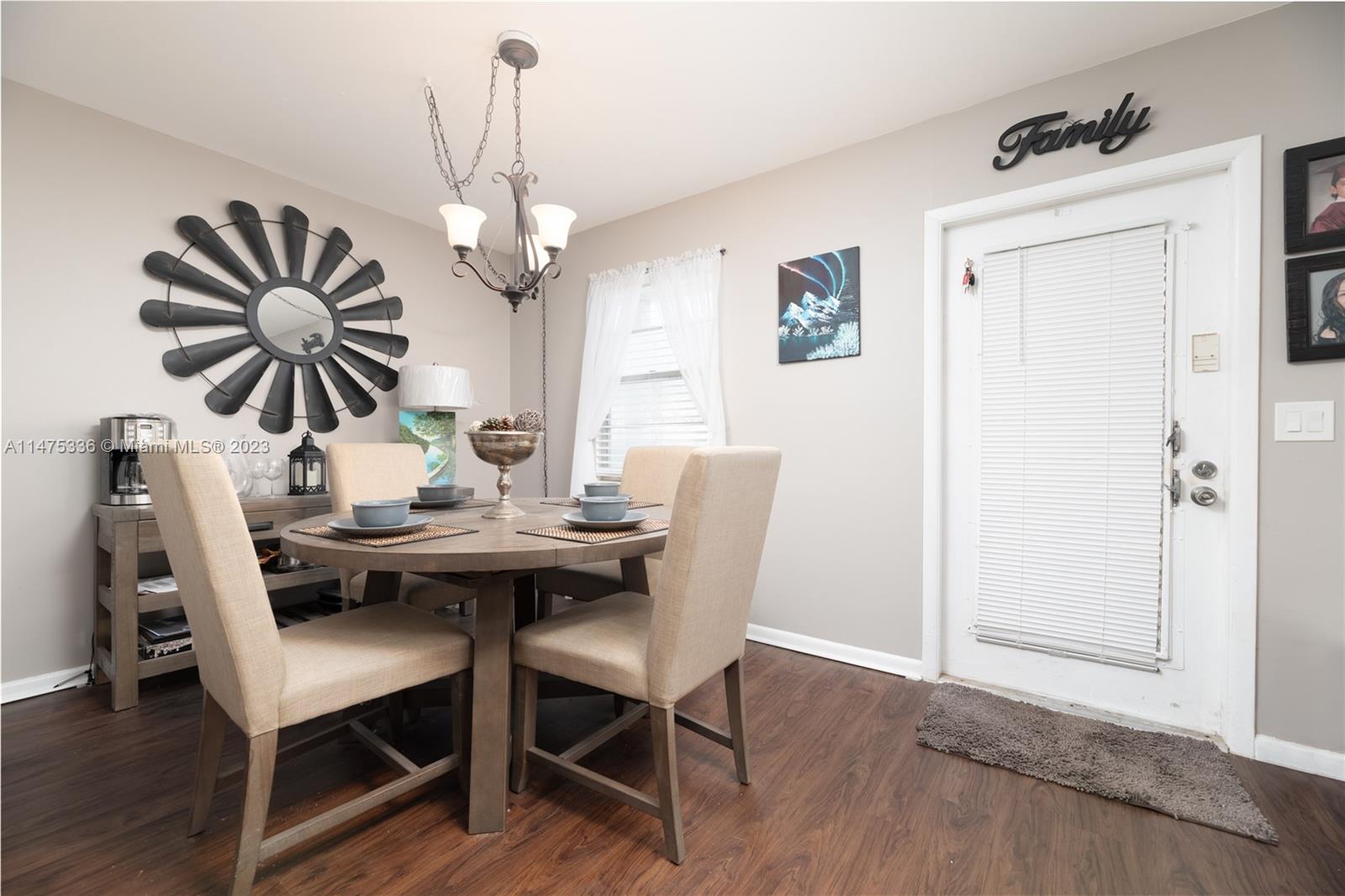 2085 Exeter, Unit 2085 Boca Raton, FL 33434 - Photo 6 of 20 a dining room with furniture potted plants and wooden floor