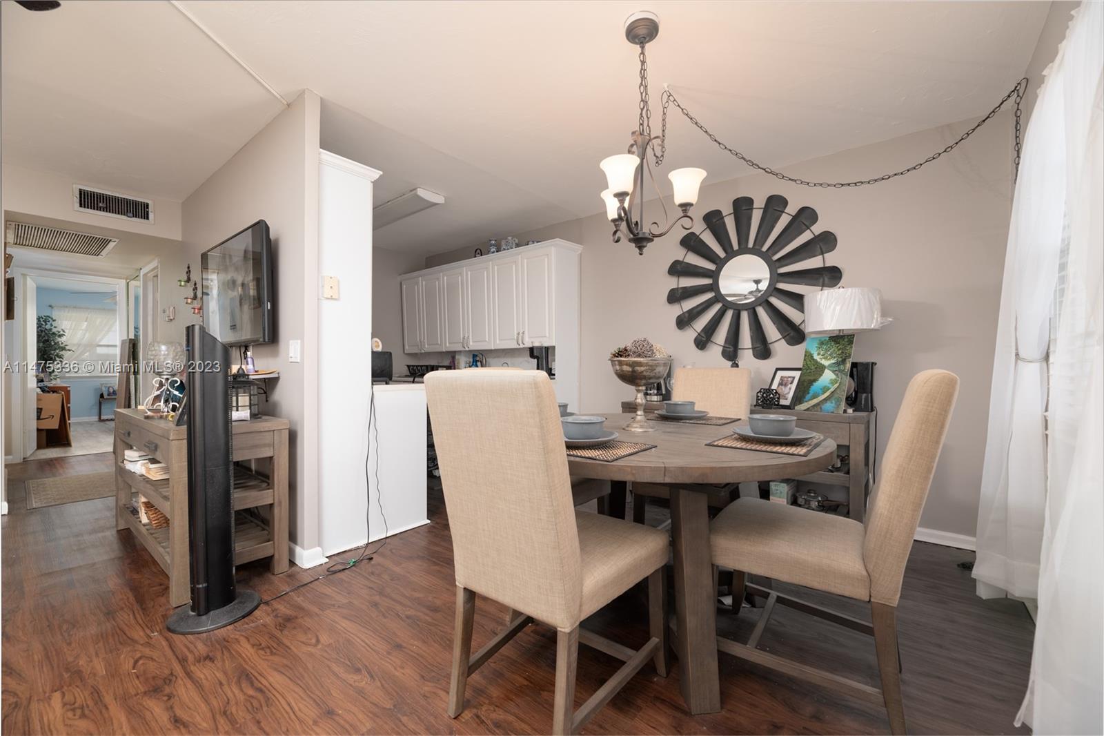 2085 Exeter, Unit 2085 Boca Raton, FL 33434 - Photo 7 of 20 a view of a dining room with furniture and wooden floor