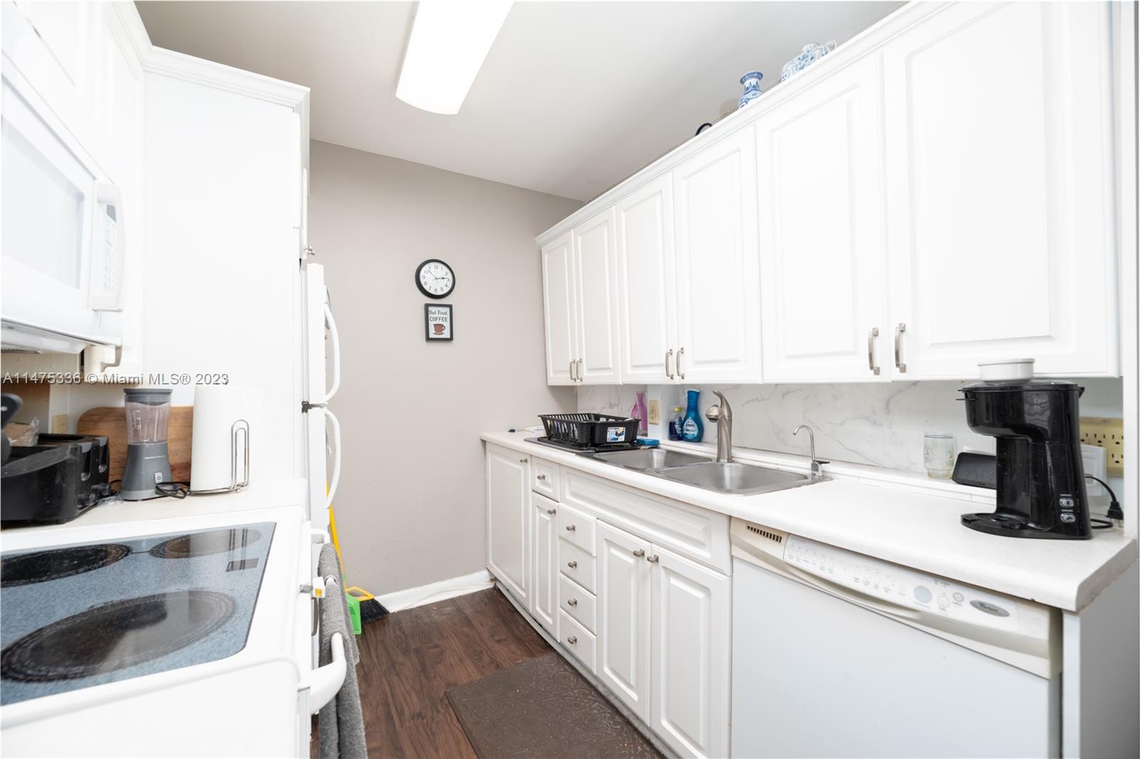 2085 Exeter, Unit 2085 Boca Raton, FL 33434 - Photo 9 of 20 a kitchen with a sink and a stove top oven