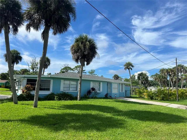 a front view of a house with a garden and yard
