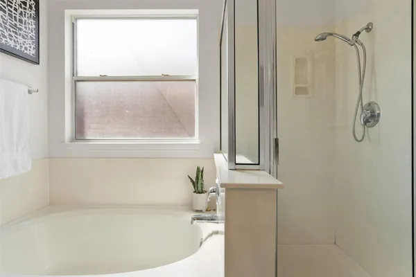 a white bath tub sitting next to a window
