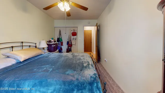 a bedroom with bed and a chandelier