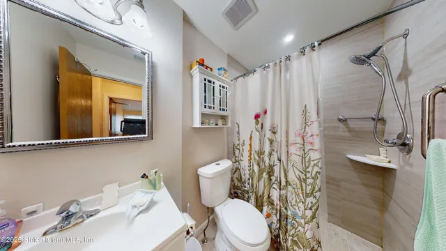 a white toilet sitting next to a bathroom sink