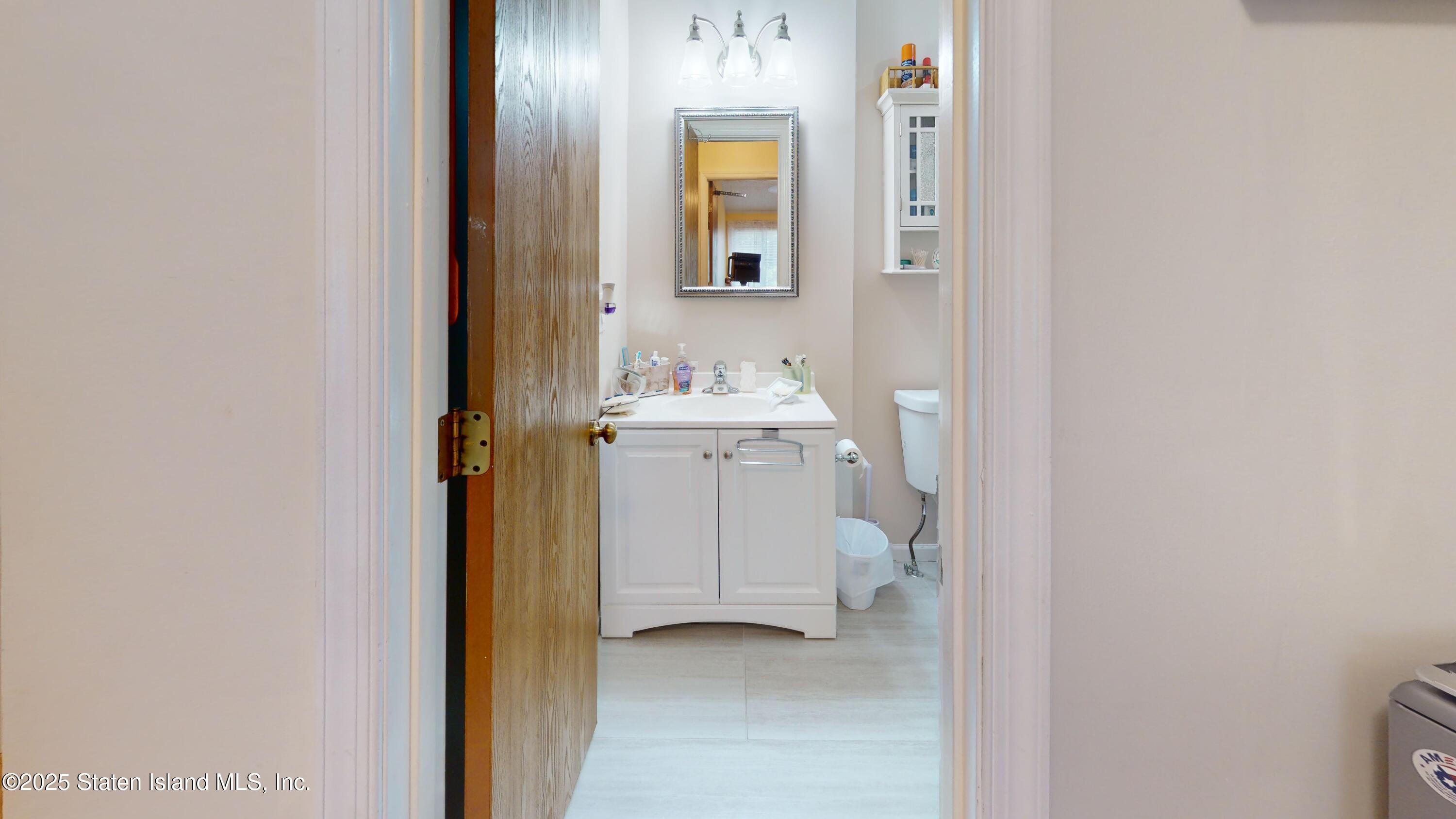 235 Ilyssa Way Staten Island, NY 10312 - Photo 15 of 30 a bathroom with a sink and a mirror