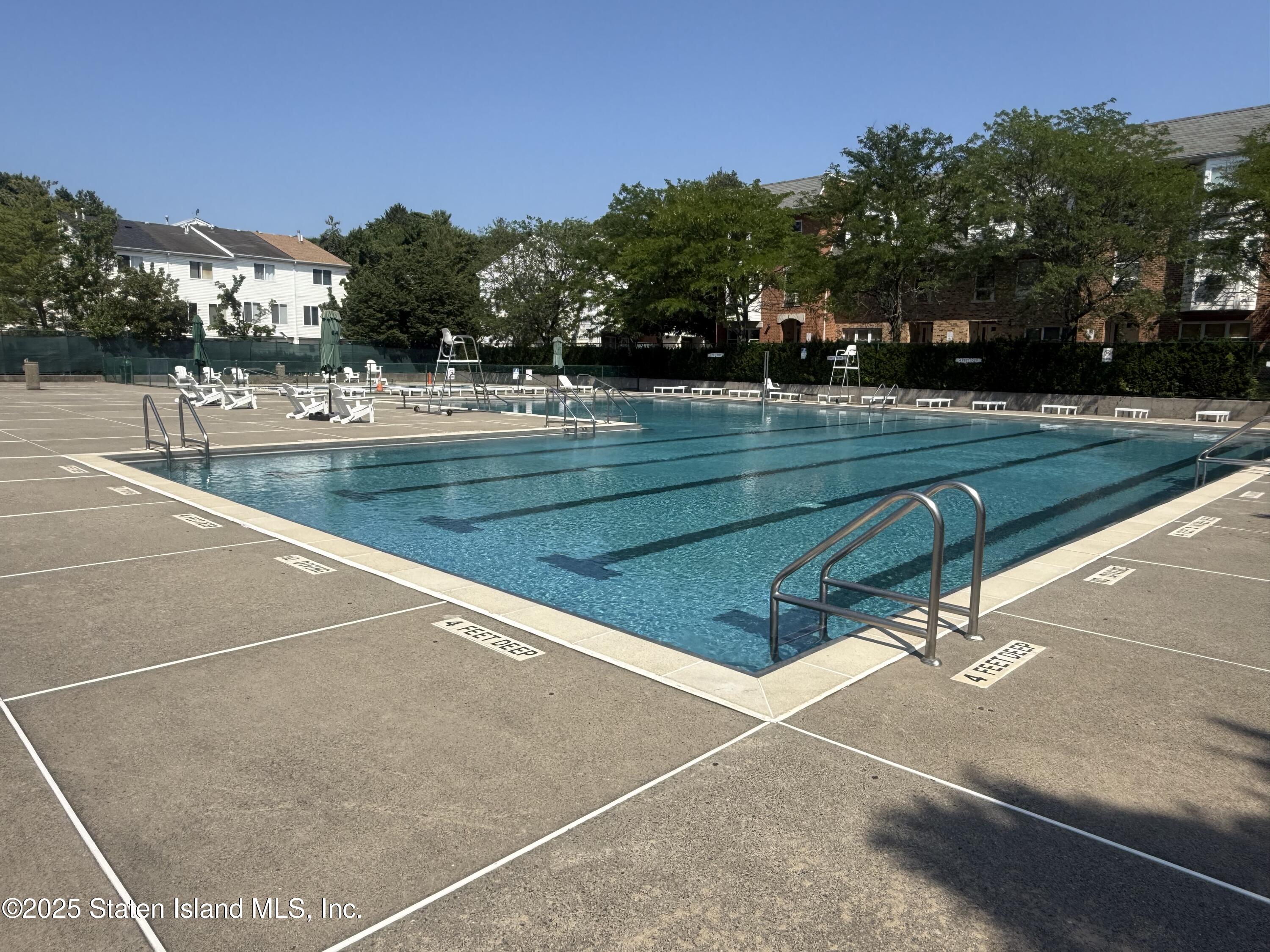 235 Ilyssa Way Staten Island, NY 10312 - Photo 30 of 30 a view of swimming pool with outdoor seating and trees in the background