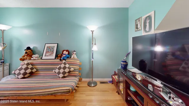 a bedroom with furniture and a lamp