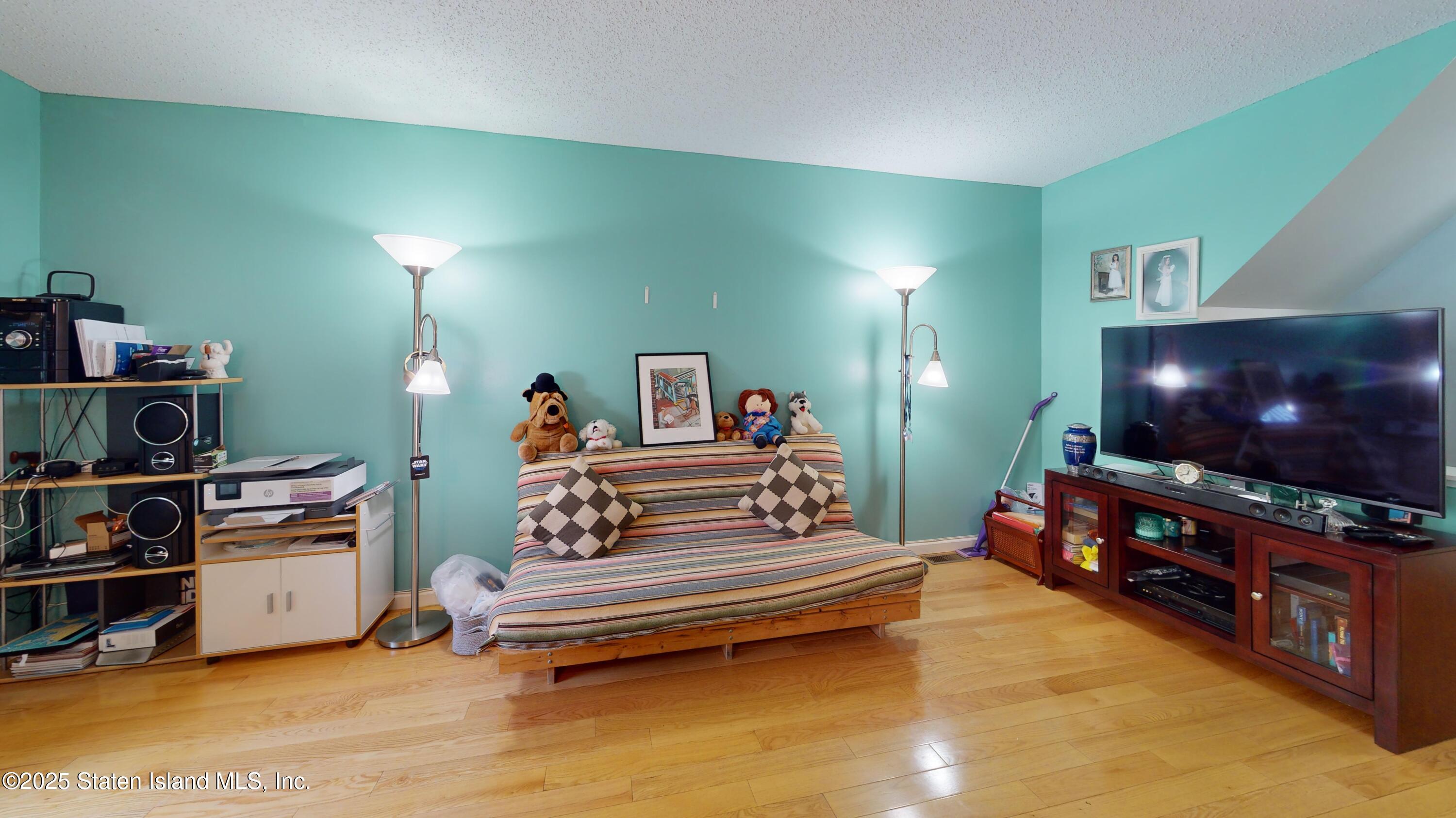 235 Ilyssa Way Staten Island, NY 10312 - Photo 10 of 30 a bedroom with furniture and a flat screen tv