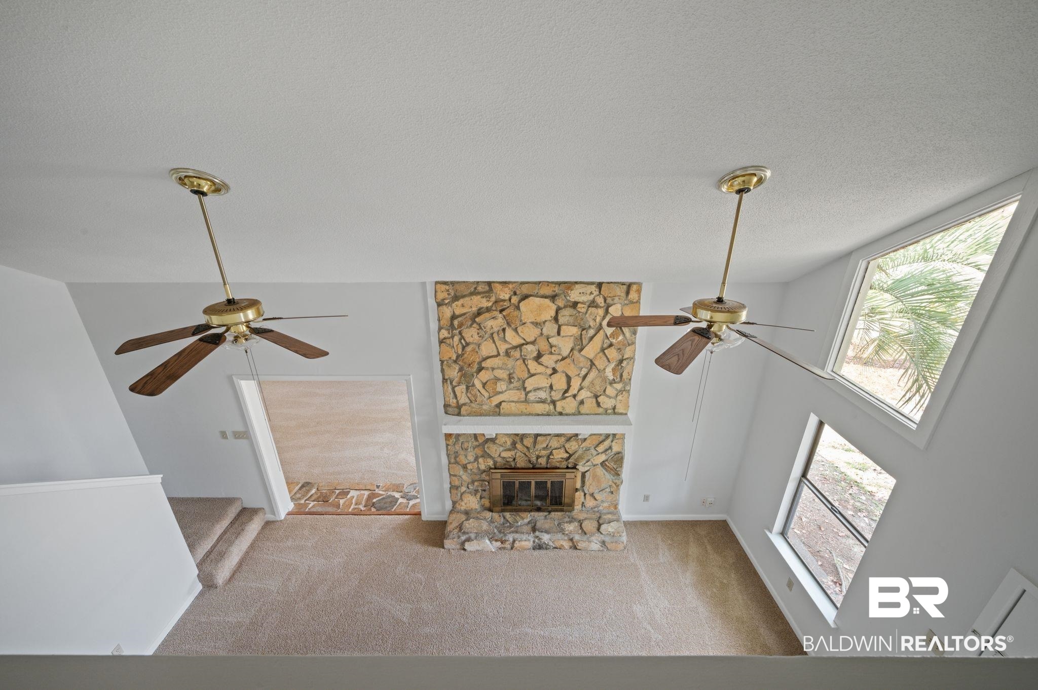 3701 Vista Ridge Drive Mobile, AL 36693 - Photo 28 of 33 Unfurnished living room featuring a fireplace, ceiling fan, and light carpet