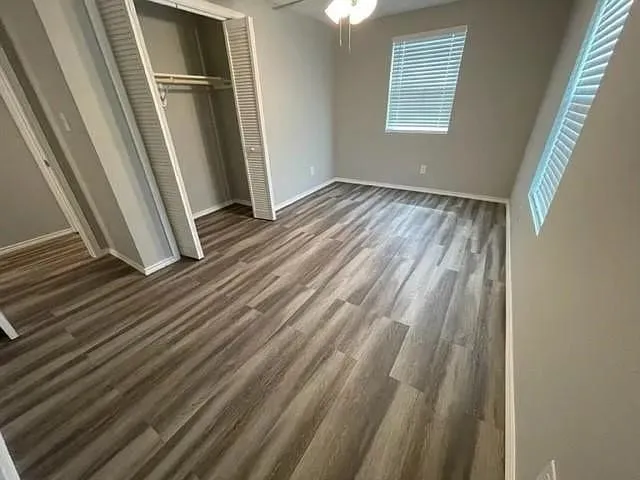 a view of a room with wooden floor and window