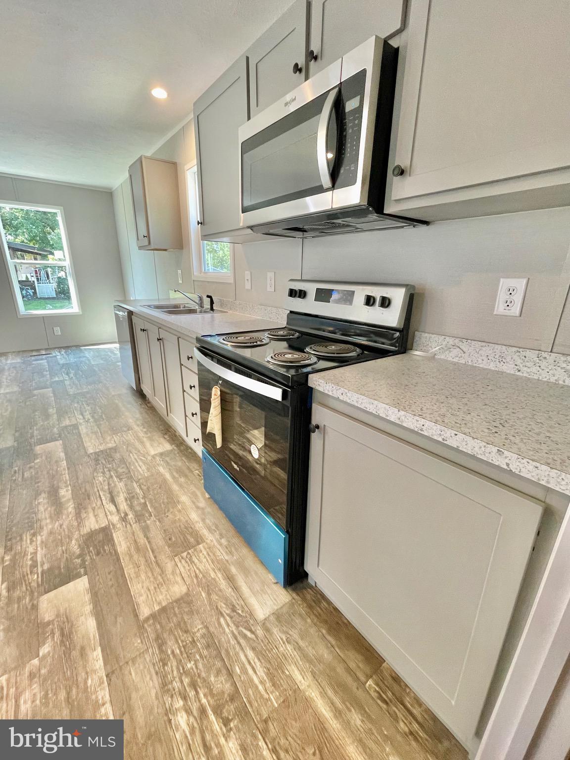 86 Cherokee Avenue Dover, PA 17315 - Photo 12 of 38 a kitchen with stainless steel appliances granite countertop a stove and a sink