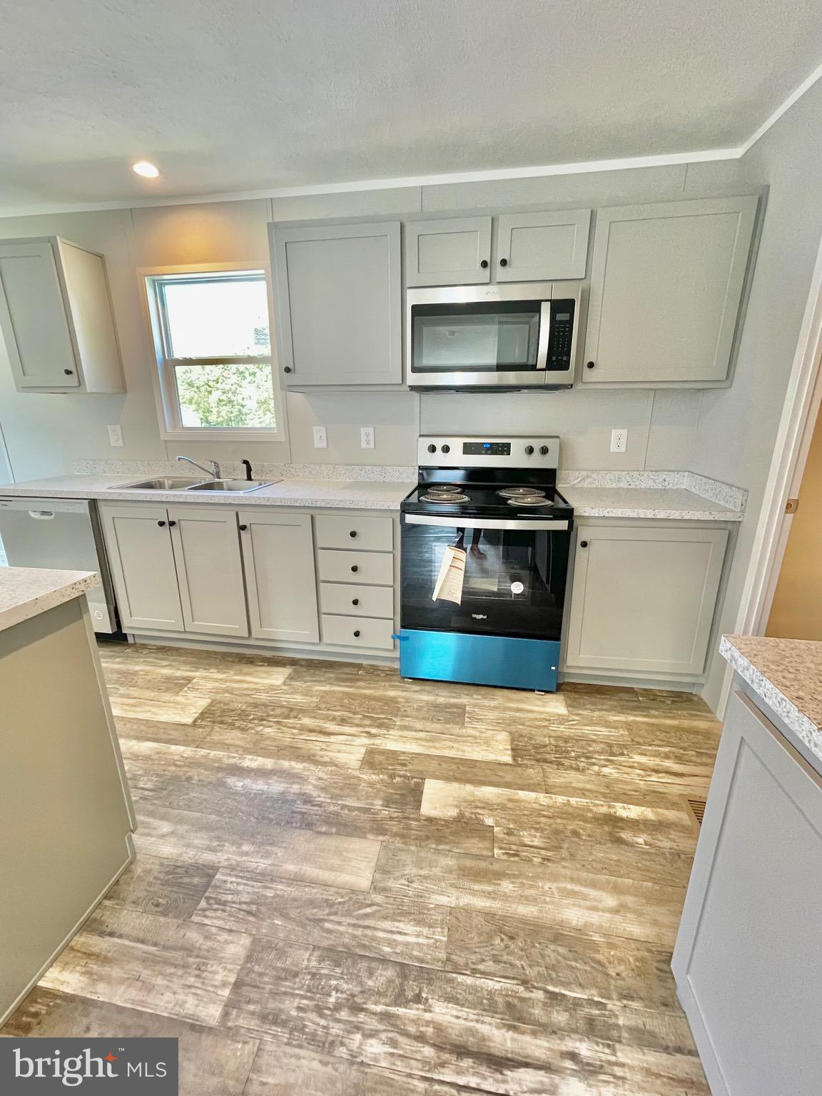86 Cherokee Avenue Dover, PA 17315 - Photo 13 of 38 a kitchen with stainless steel appliances granite countertop a stove a sink and a microwave