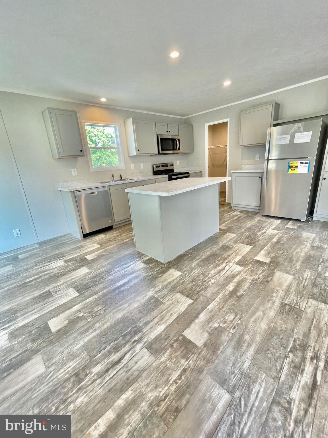 86 Cherokee Avenue Dover, PA 17315 - Photo 15 of 38 a large white kitchen with kitchen island a sink a counter space and a window