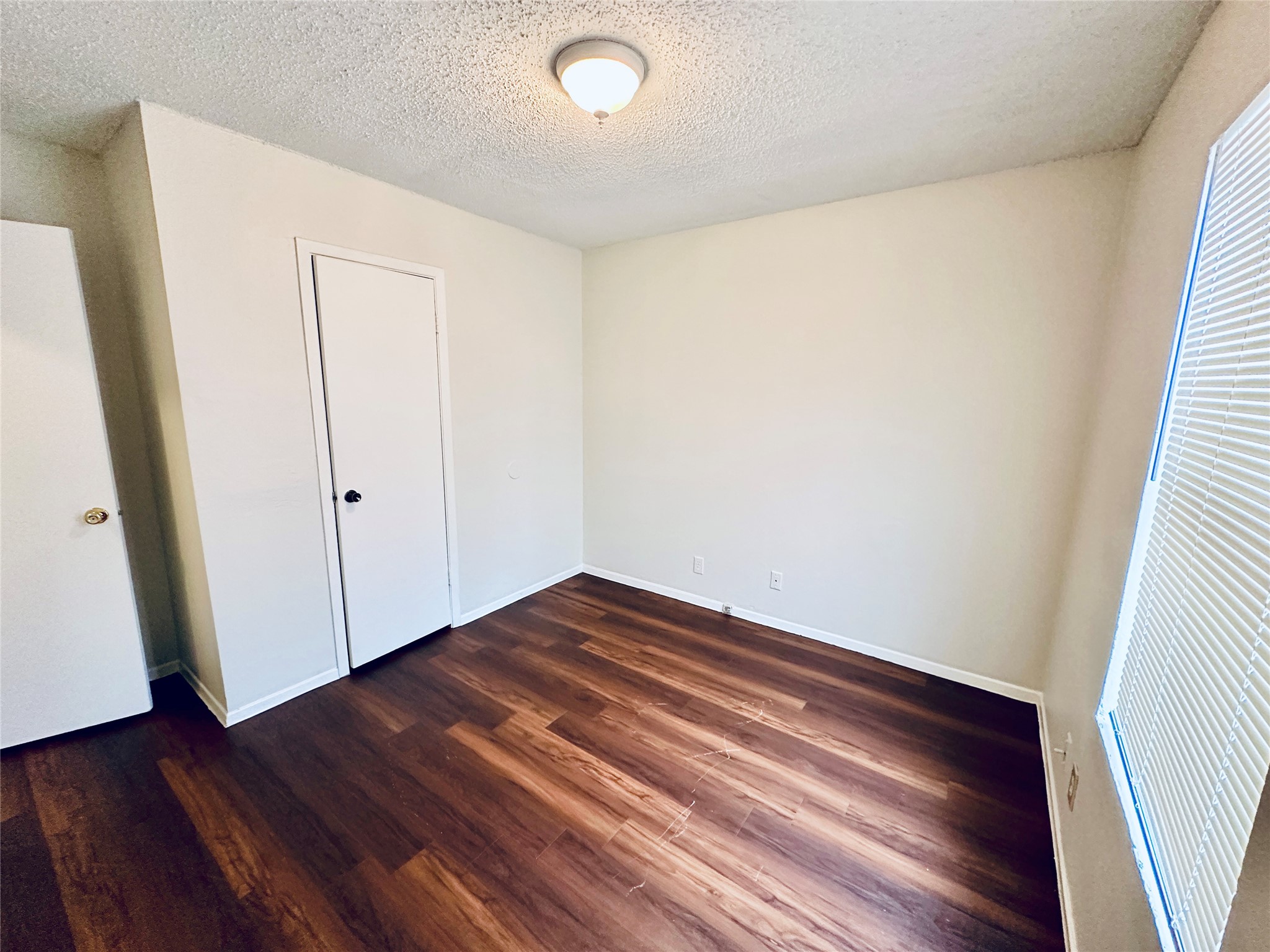 12505 Turtle Rock Road, Unit A Austin, TX 78729 - Photo 25 of 38 Rich hardwood-style flooring extends across this naturally lit, inviting room, featuring a private closet.